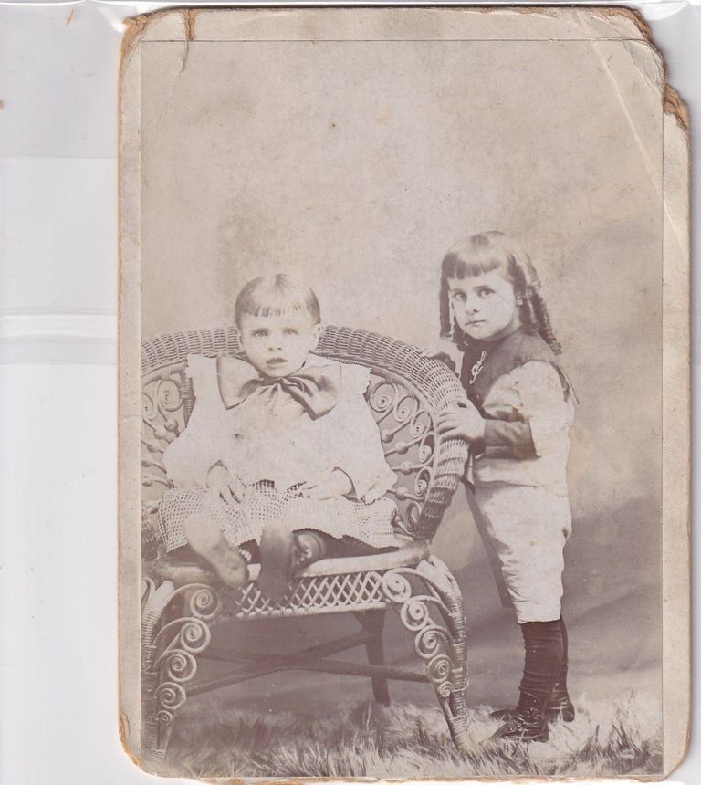 Sibling Portrait of Young Boy and Girl with Wicker Studio Chair