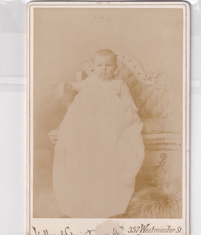 Infant in Long Christening Gown on Ornate Settee — Lothrop & Cunningham Studio Portrait