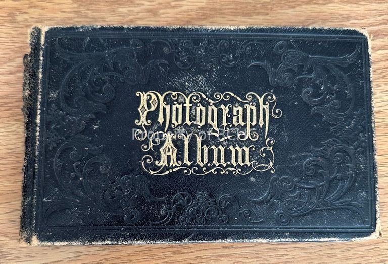 This photograph album was also used as an autograph book. Contains small portraits of people with names and some inscription.