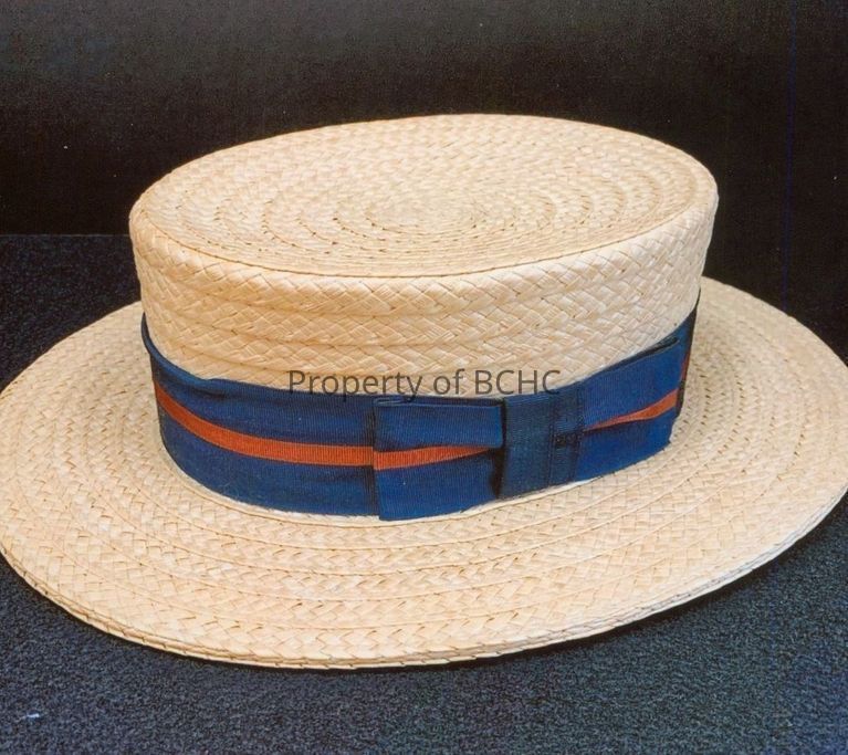 Men's straw hat with a band of navy and red ribbon.
