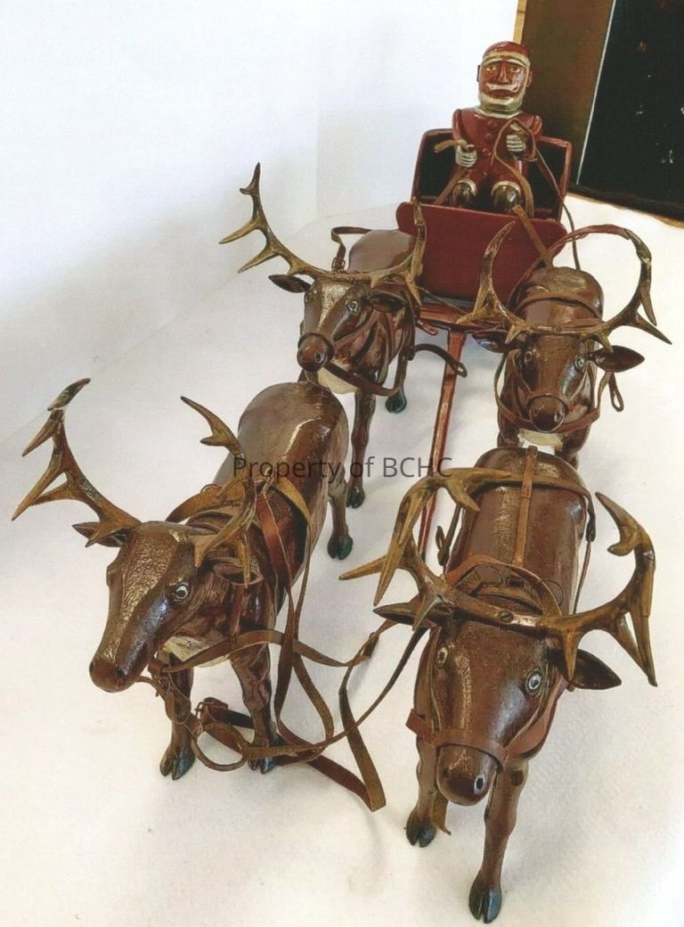 Painted wood carving of Santa in sleigh with four reindeer by folk artist, Adelard Coté