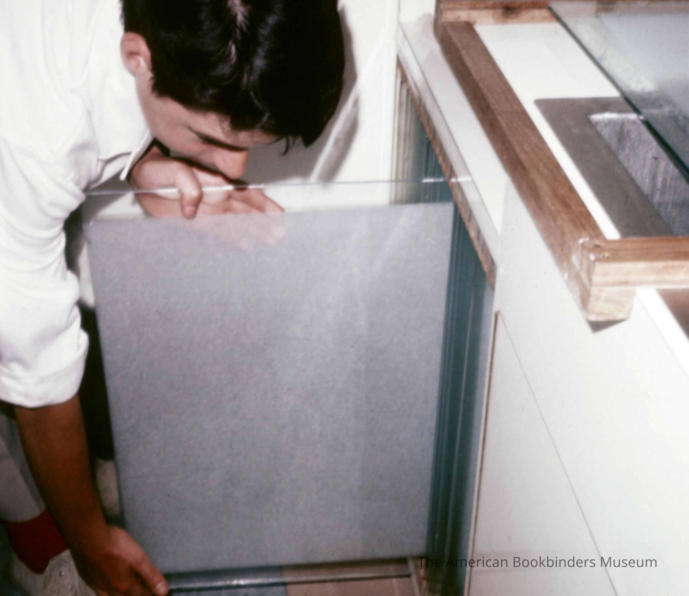          A scan of a slide showing someone removing a transparent plane picture number 1
 