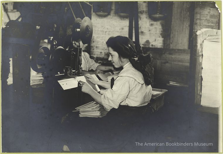 1910 Photograph of a woman hand saddle stitching a magazine picture number 1