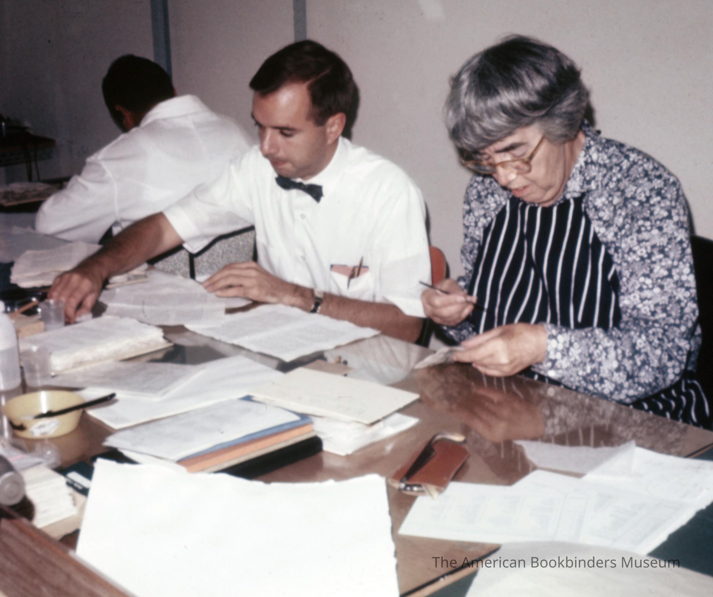          A scan of showing three conservators at work picture number 1
 