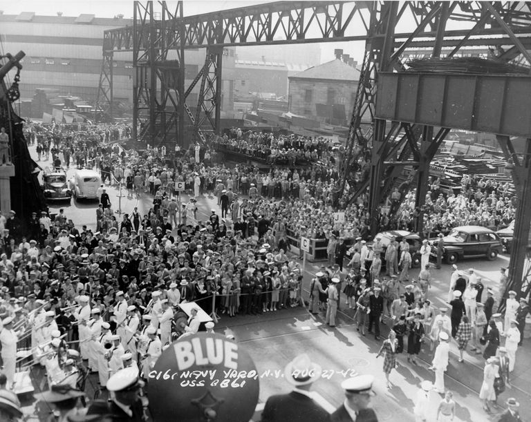          USS Iowa shipyard workers and guests face the launch stand. Note a Navy band performing in the lower left. F1111C161 picture number 1
   