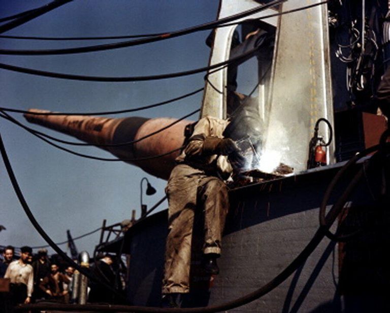 A welder constructs the face of one of IOWA's 16 inch gun turrets. October 1942 - 80-G-K-509 also 80-G-K-512 picture number 1
