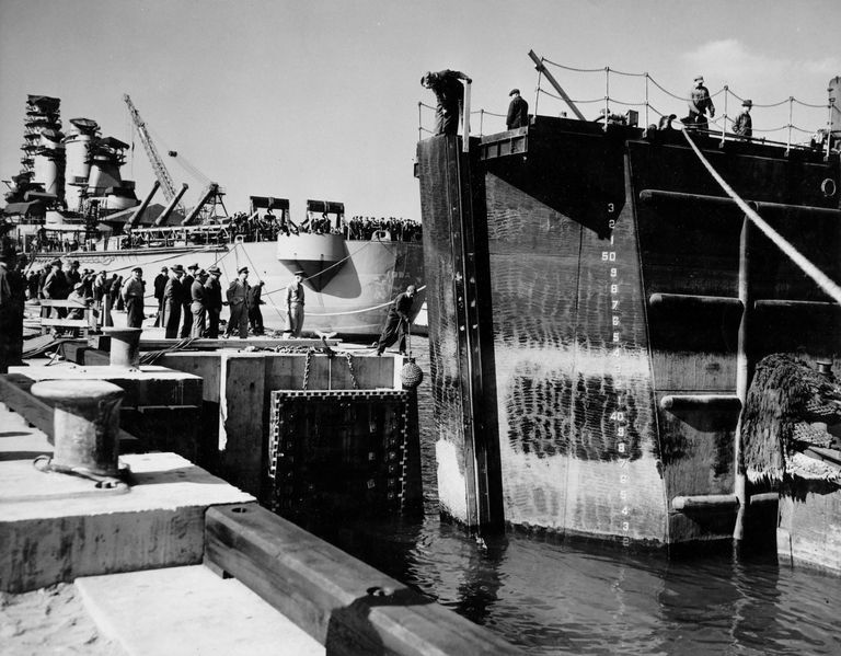          Tug boats push the caisson into its final position to seal the dry dock. October 20, 1942 - 80-G-13560 picture number 1
   