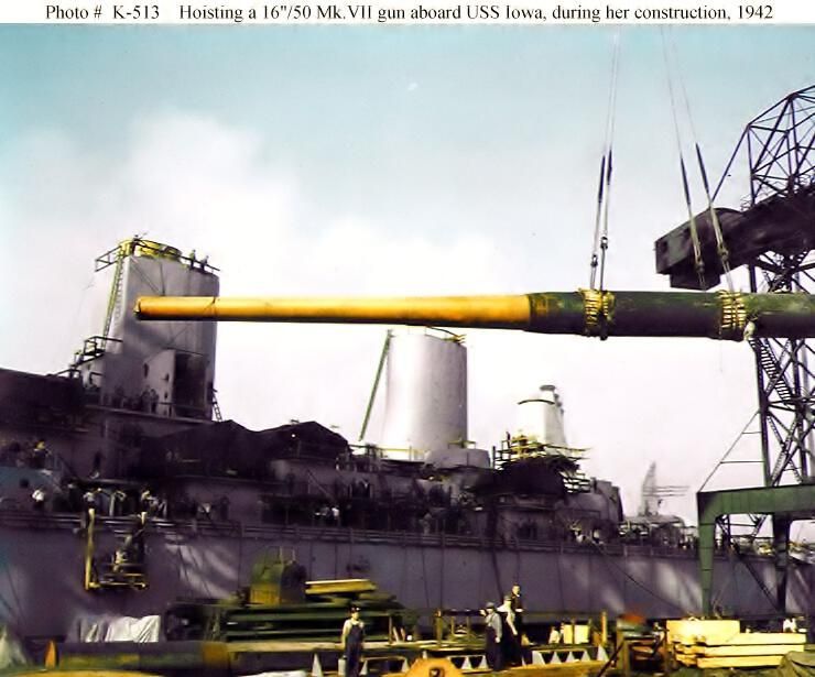          A crane hosts a 16 inch gun barrel onto IOWA for installation. Note the two stacks in the background. Fall 1942 - 80-G-K-513 picture number 1
   