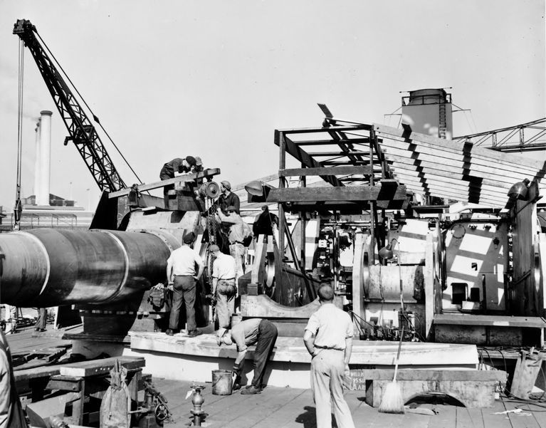 USS Iowa's forward Main Deck - shipyard workers install one of the 16 inch Mark 7 gun barrels in Turret 1. Fall 1942 - 80-G-K-507 picture number 1