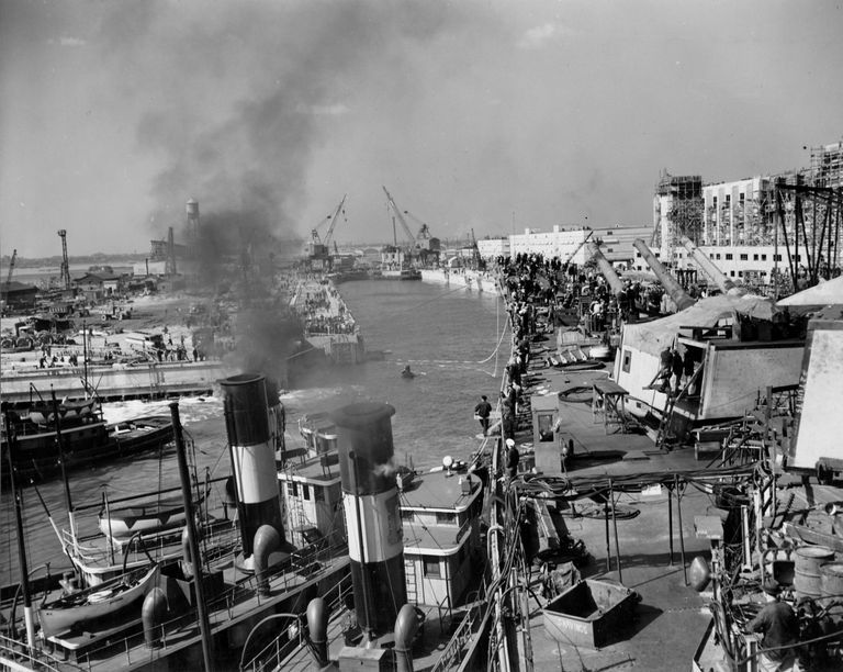          Tug boats guide IOWA into the entrance of the dry dock. October 20, 1942 - 80-G-13573 picture number 1
   