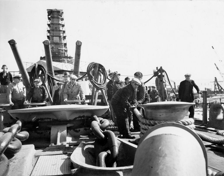          Workers on IOWA's bow man the anchor windless wheels, while others make line adjustments. October 10, 1942 - 80-G-13578 picture number 1
   