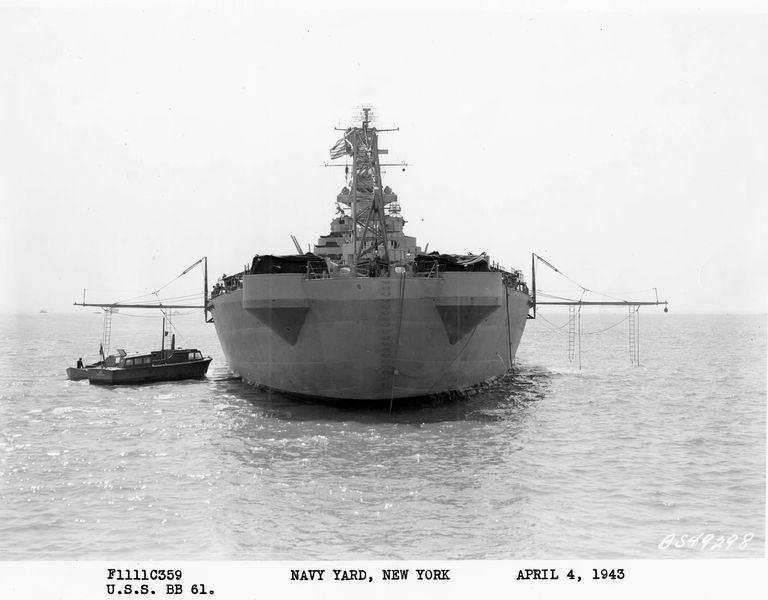          Stern view of USS Iowa anchored off New York with boat booms rigged. April 4, 1943 - F1111C359. picture number 1
   