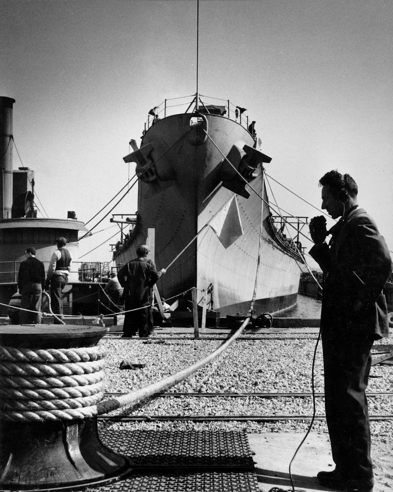          A shipyard worker communicates with the docking crew as IOWA's final position over her keel blocks is secured. October 20, 1942 - 80-G-13563 picture number 1
   