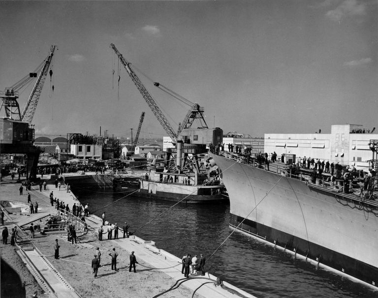          Workers continue to adjust lines to position IOWA over her keel blocks in dry dock. October 20, 1942 - 80-G-13561 picture number 1
   