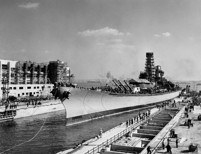          Tug boats push IOWA further into her dry dock as lines are sent out to workers on shore. October 10, 1942 - 80-G-13556 picture number 1
   