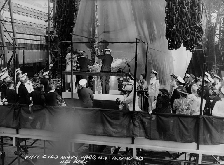          Sponsor Mrs. Wallace breaks a bottle of champagne on battleship Iowa's bow, signaling the ship to be launched. F1111C163 picture number 1
   