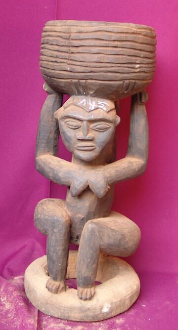 Female figure holding a container