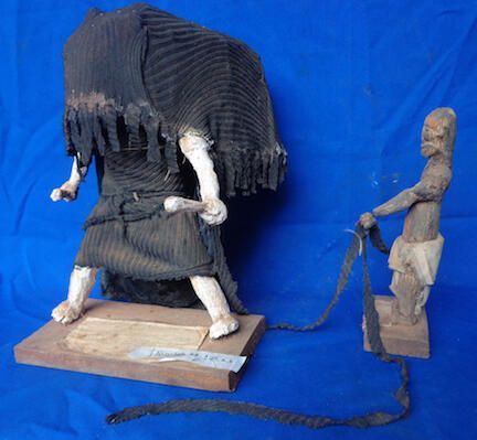 Figure of masquerade and attendants