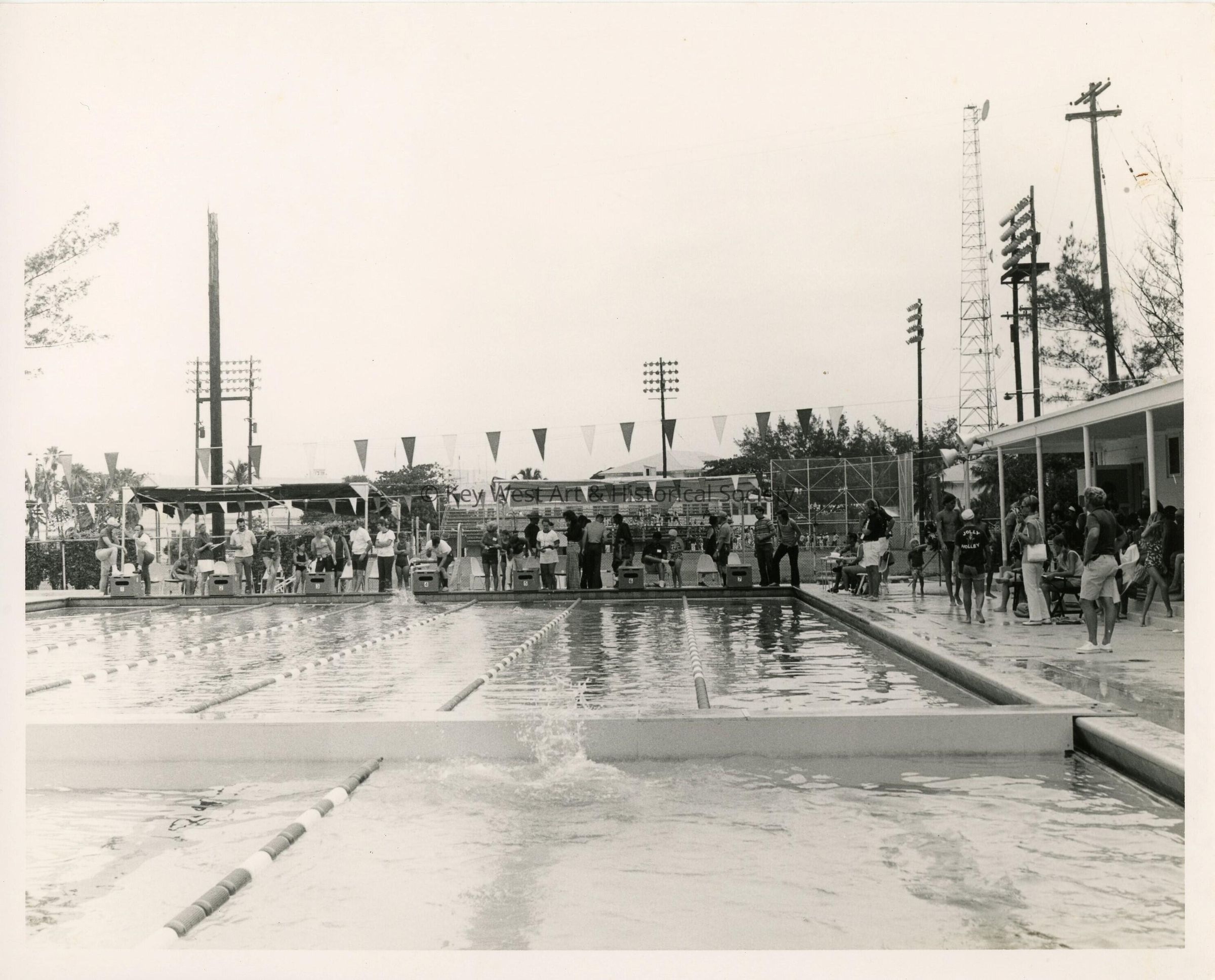 A group of unknown people at a pool