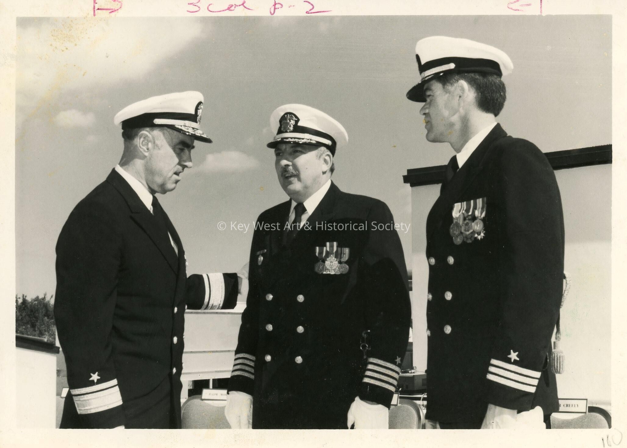 3 Unknown men in uniform talking