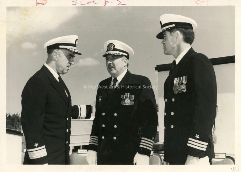 3 Unknown men in uniform talking