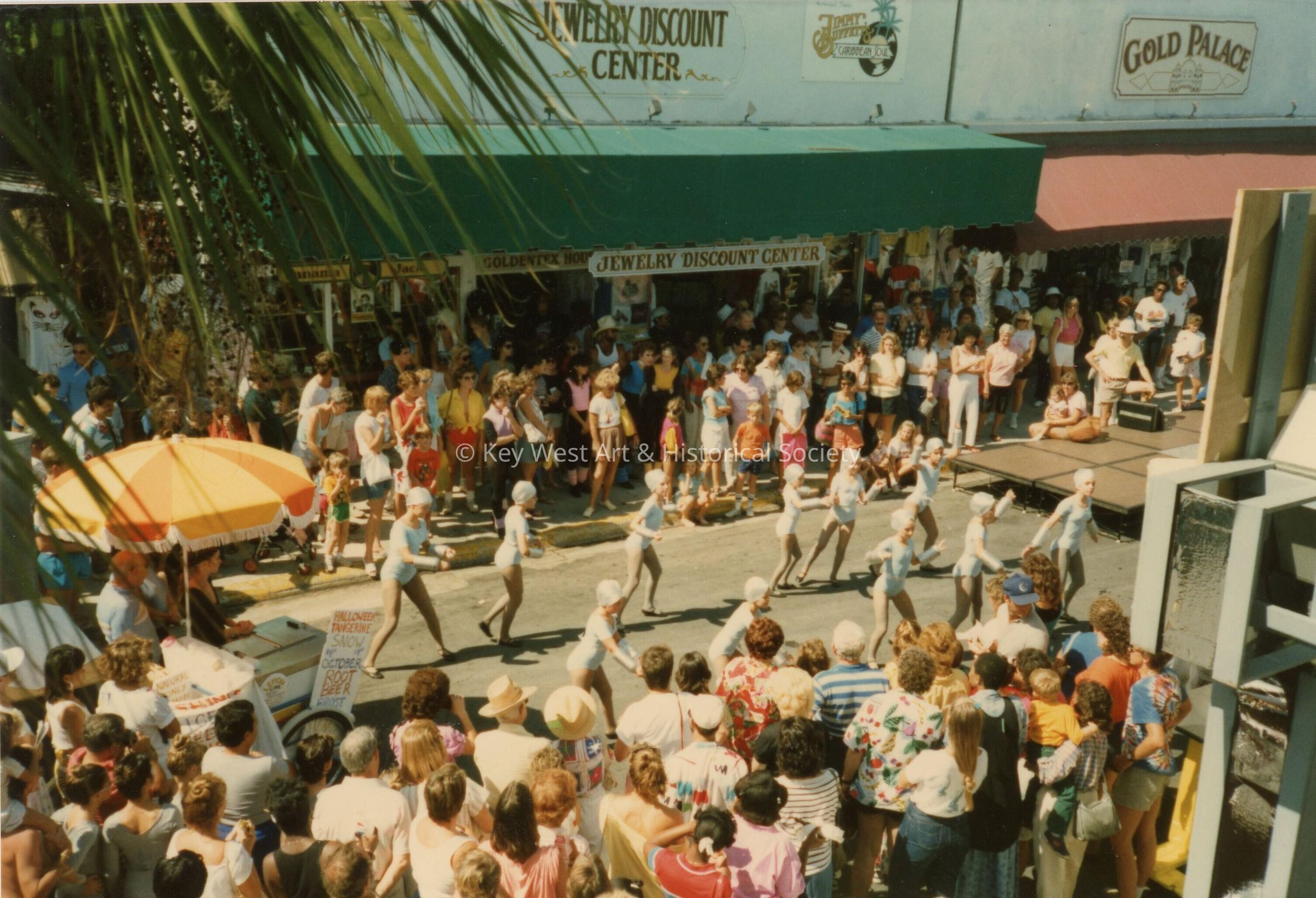 A group of unknown people dancing in the street.