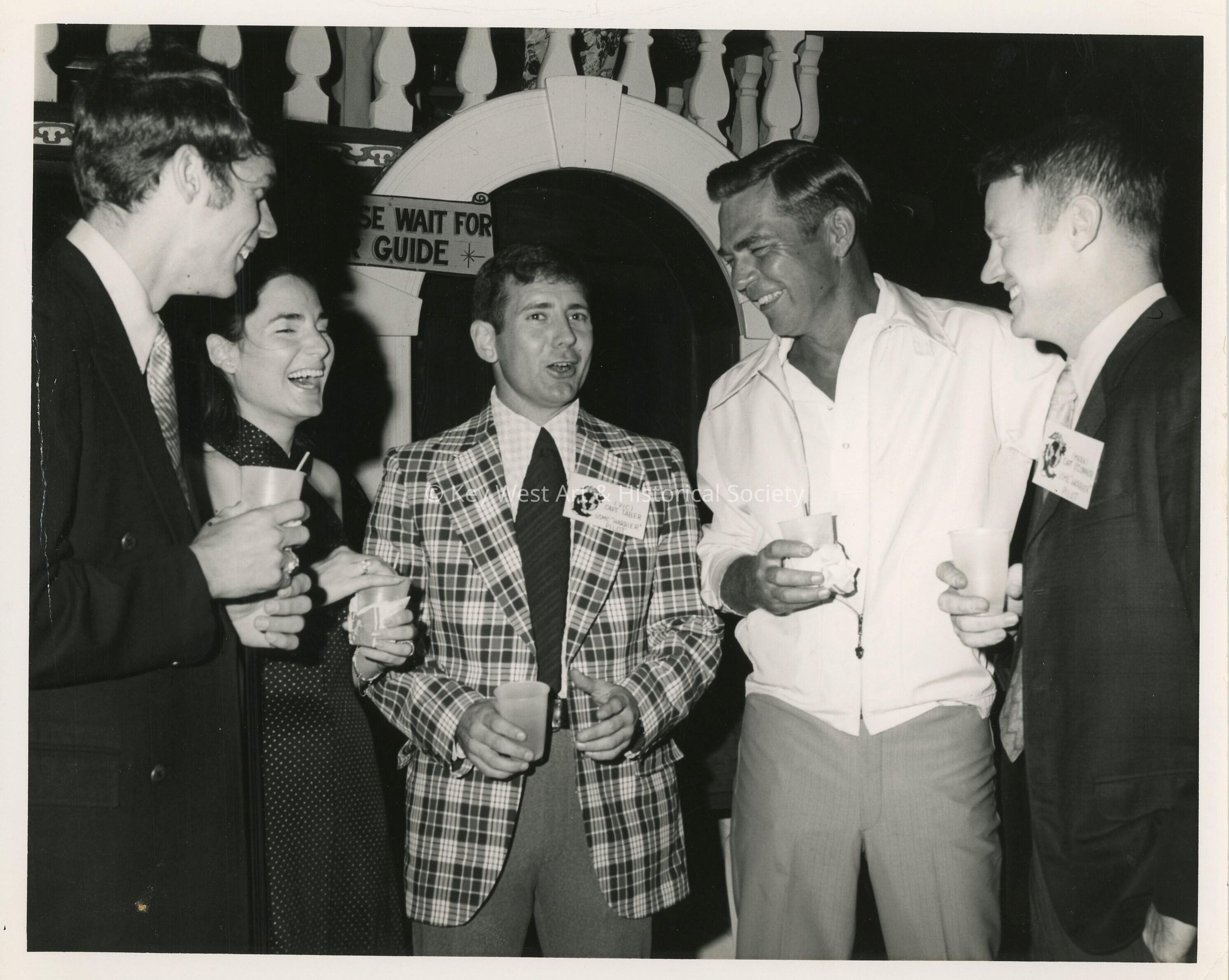 An Unknown group of people talking at a party