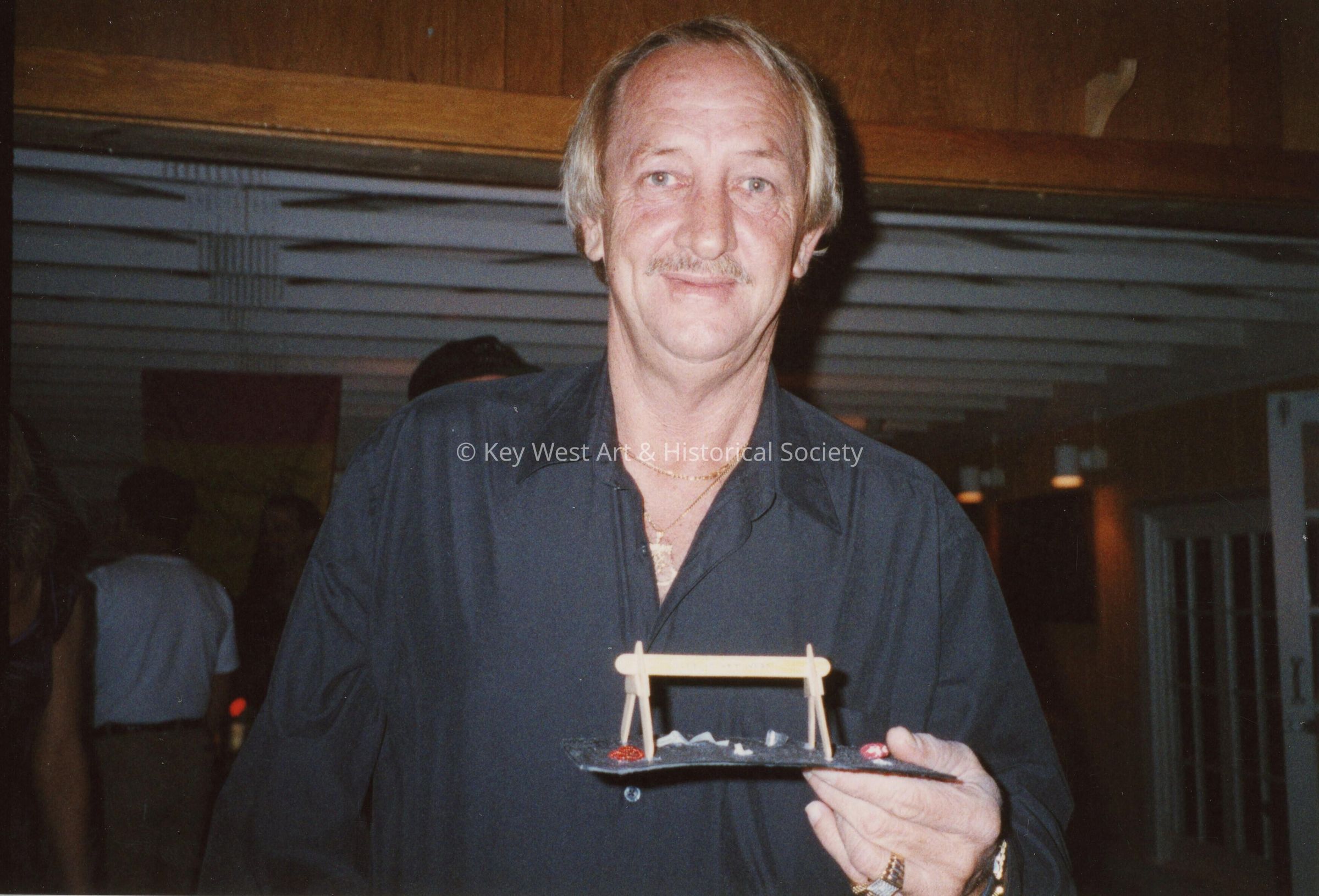 An unknown man at an award ceremony.