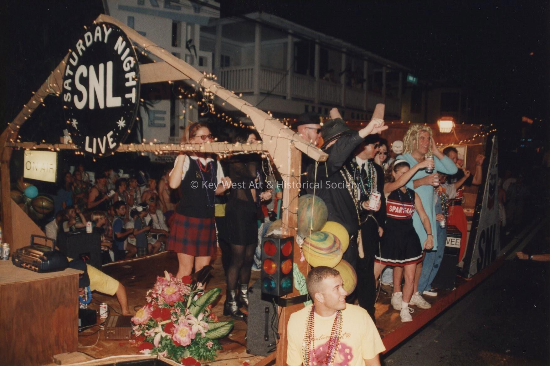 A float in the parade that reads Saturday night live.