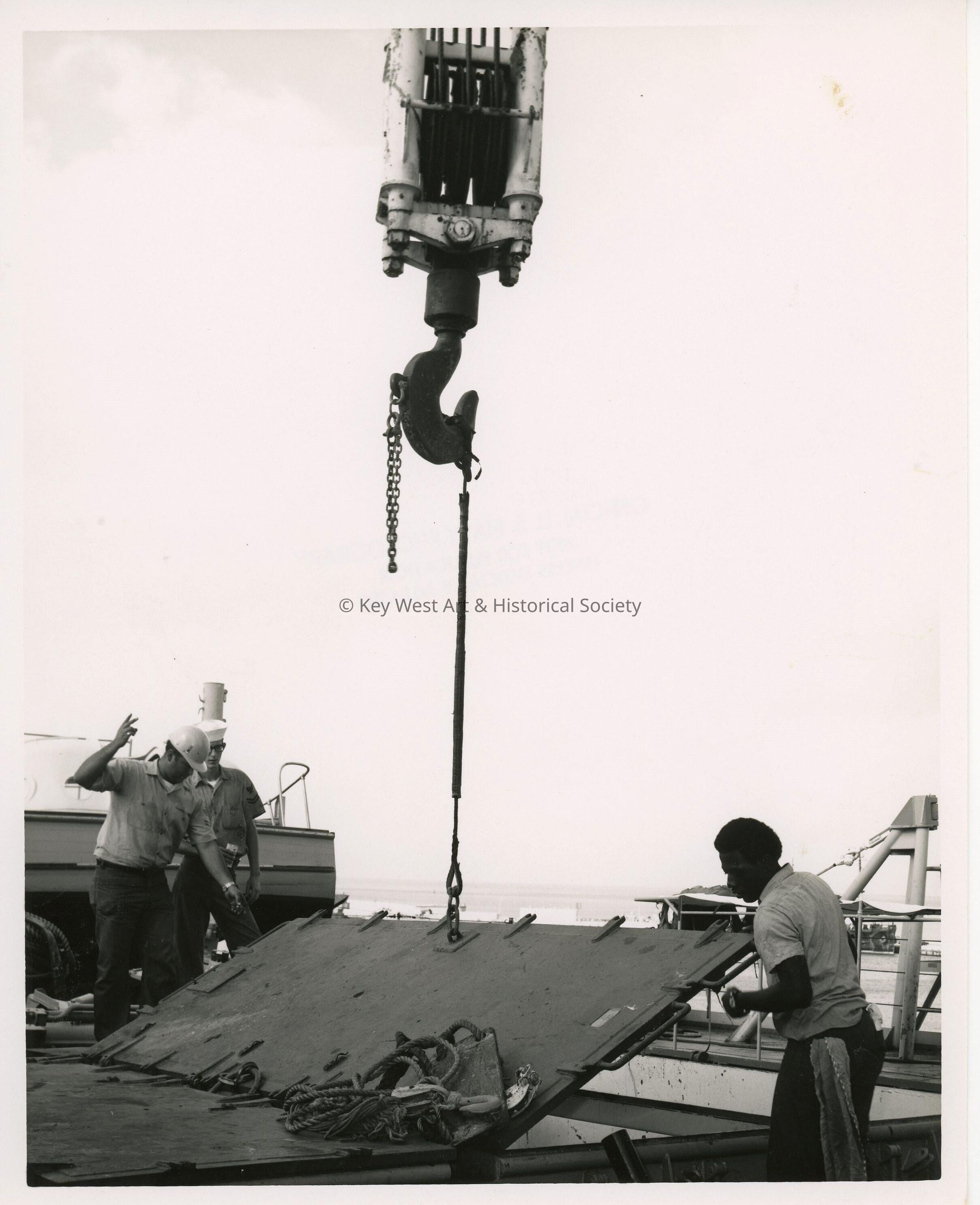 A crane pulling something a U.S. Navy dock