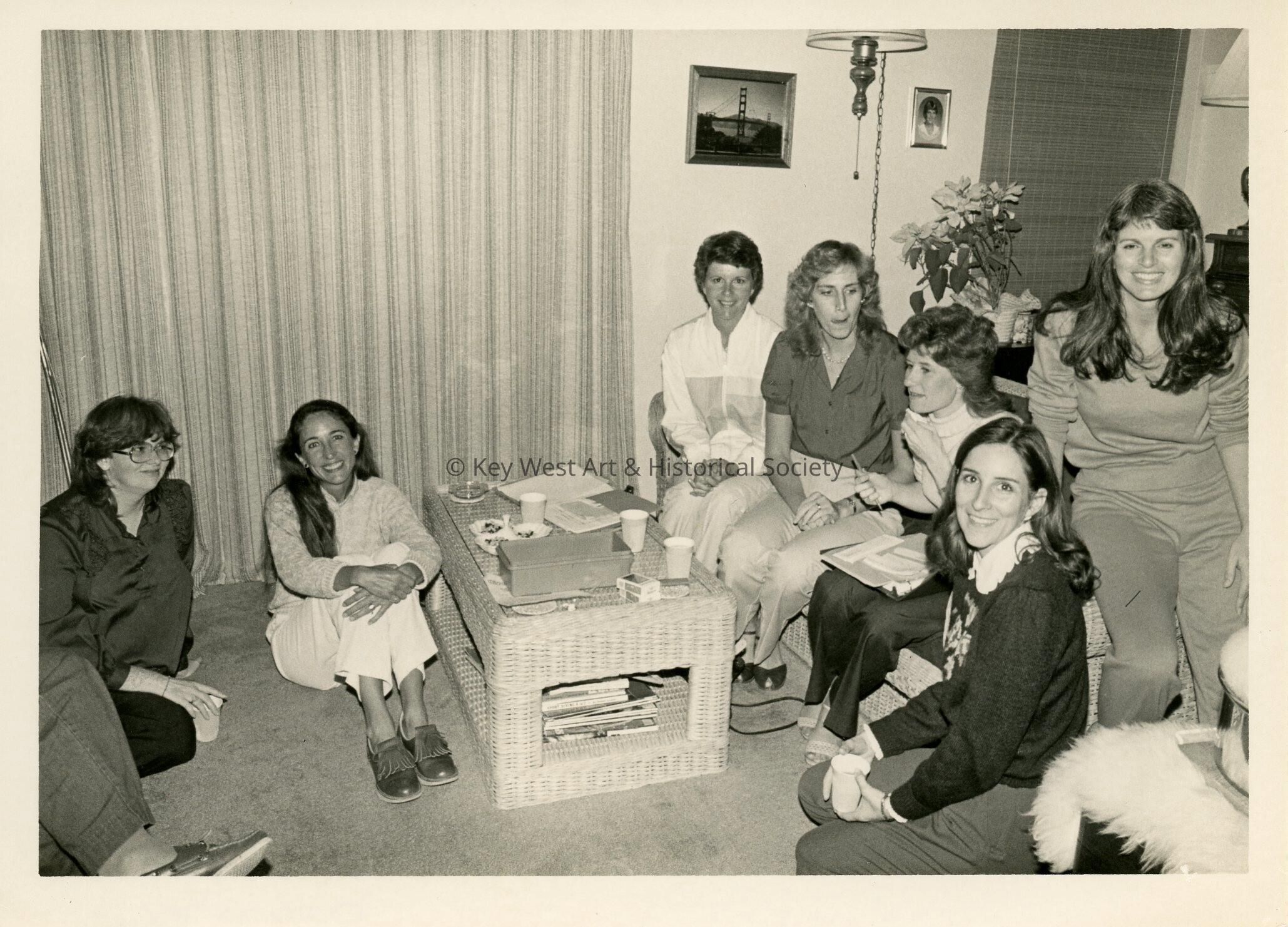 A group of unknown woman sitting in a living room