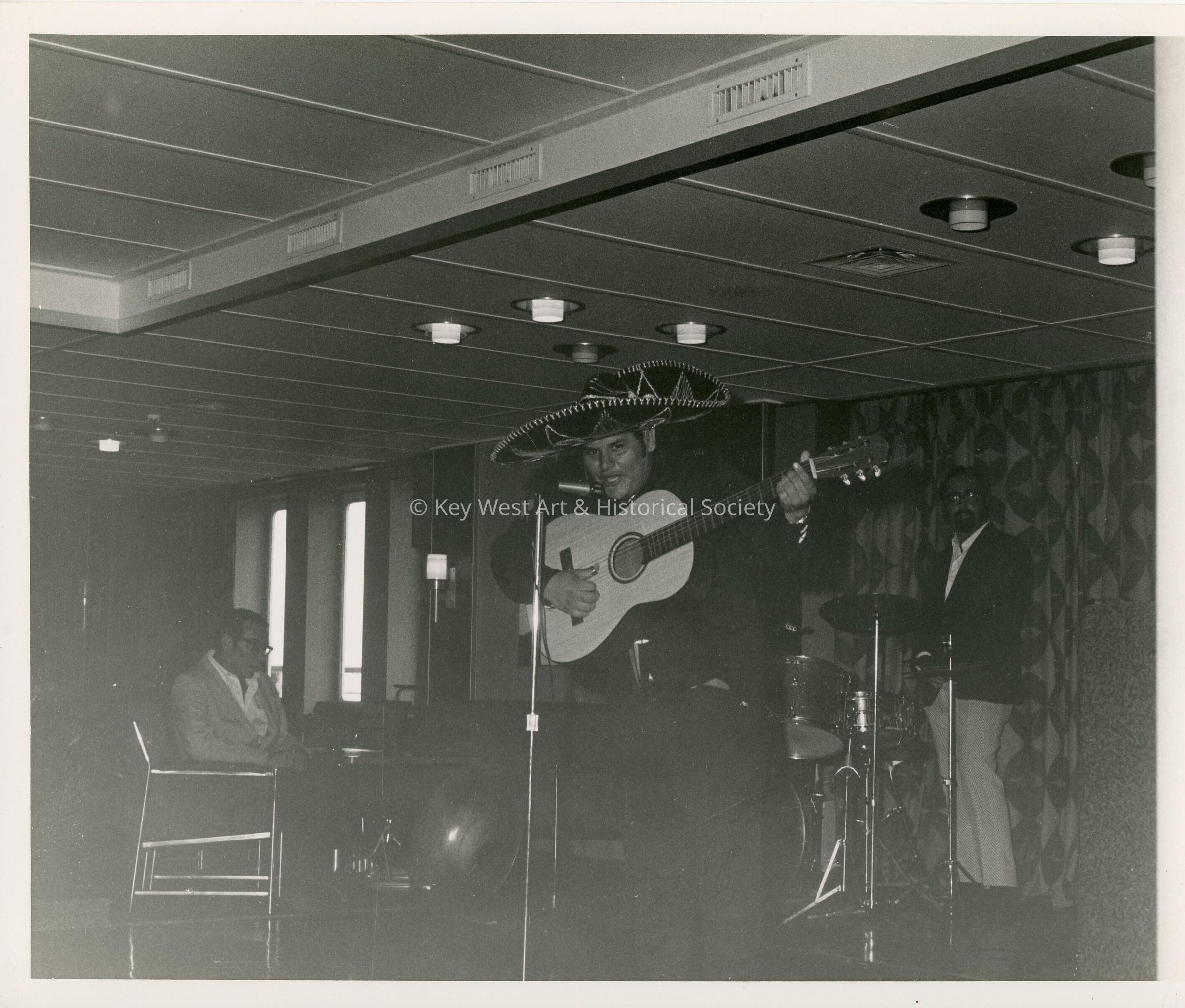 An unknown man singing in a band