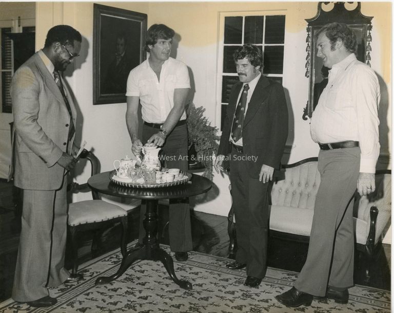 4 Unknown men standing inside at a party