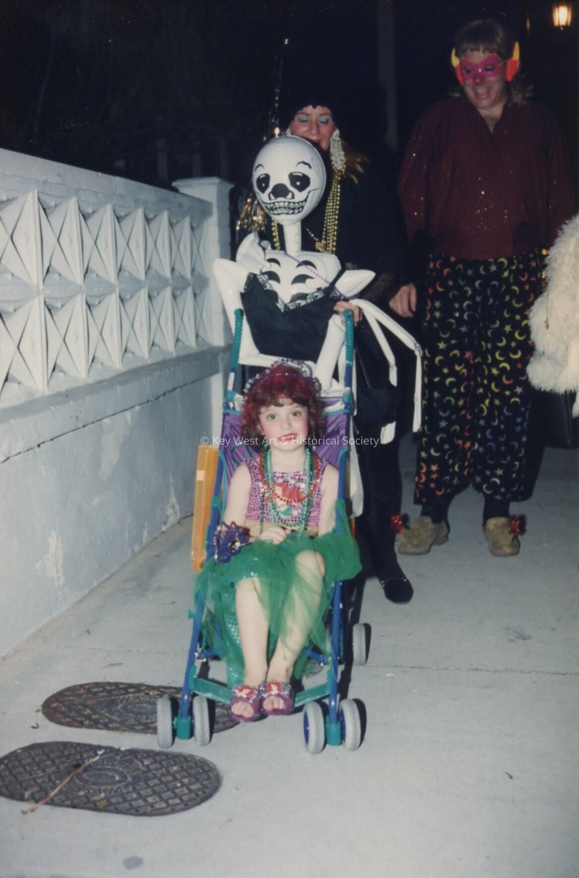 An unknown family dressed up walking.
