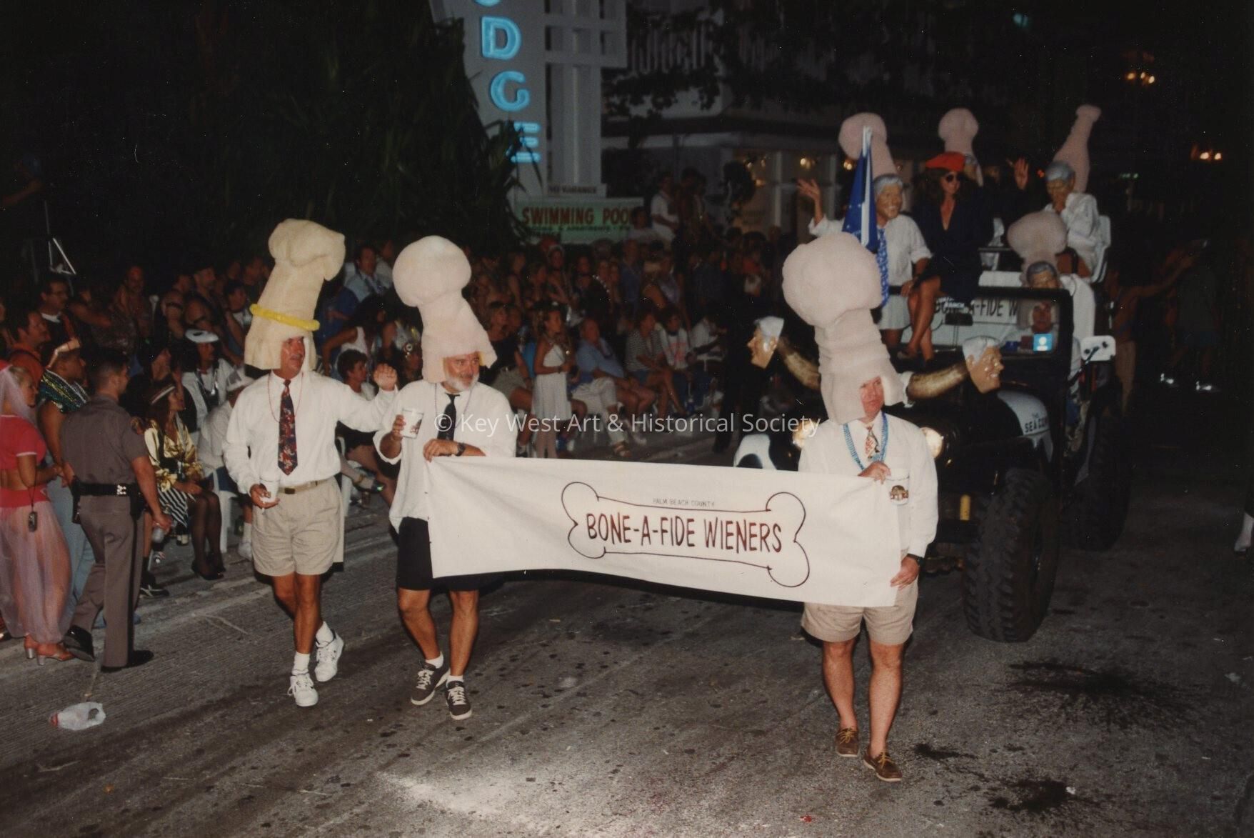 A float and banner in the parade, banner reads Bone a fide wieners.