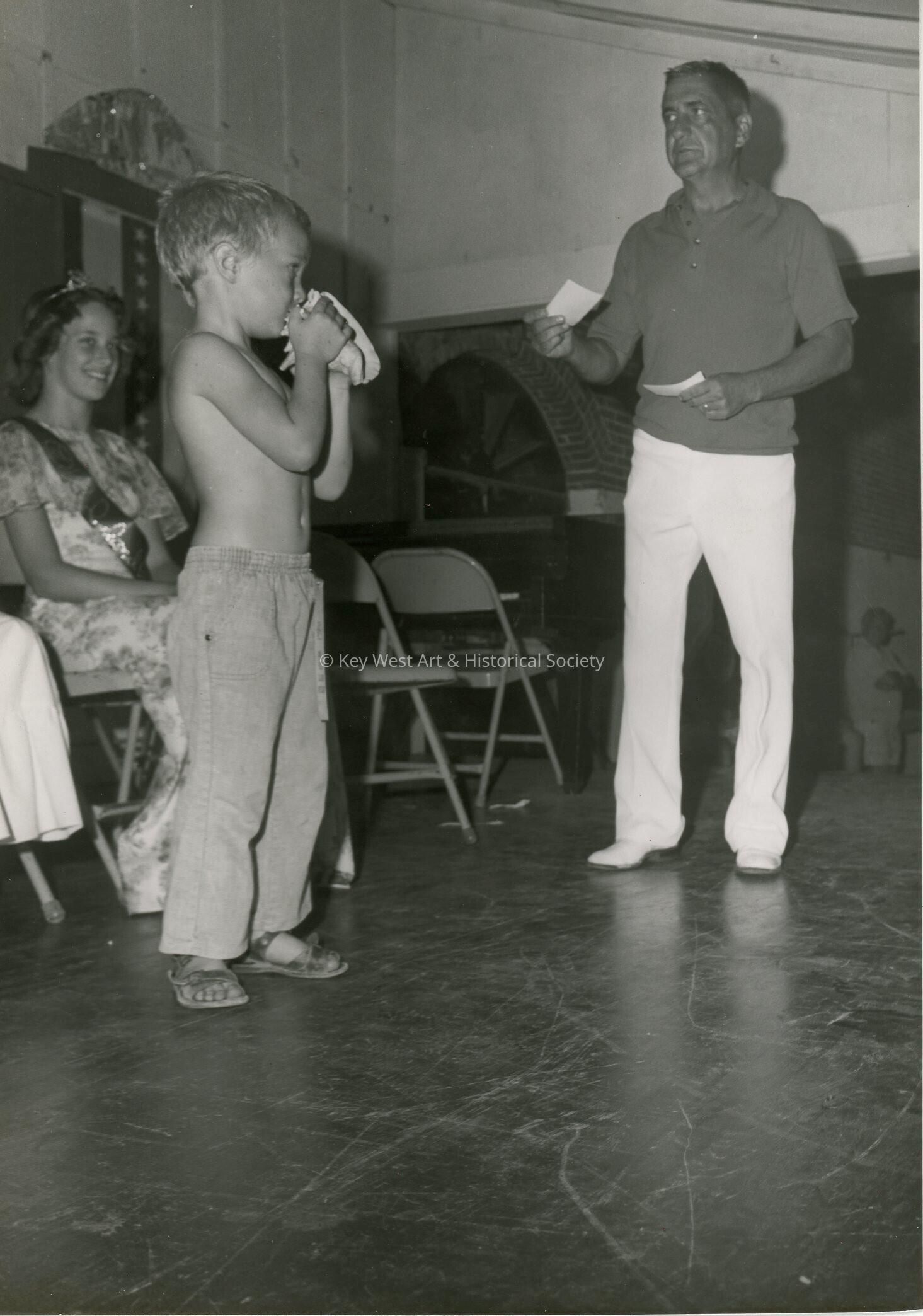 A child blowing a conch