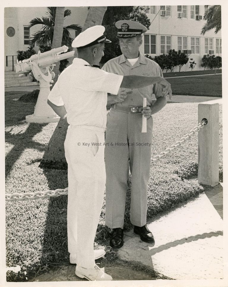 2 Men in uniform talking to each other on base