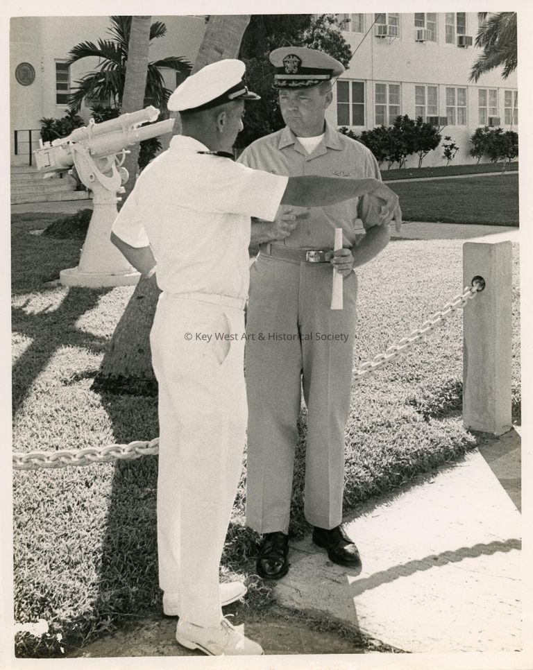2 Men in uniform talking to each other on base