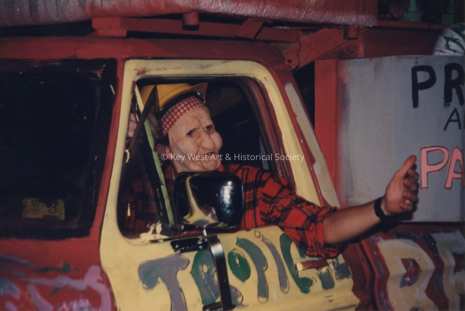 An unknown man dressed up driving one of the floats.