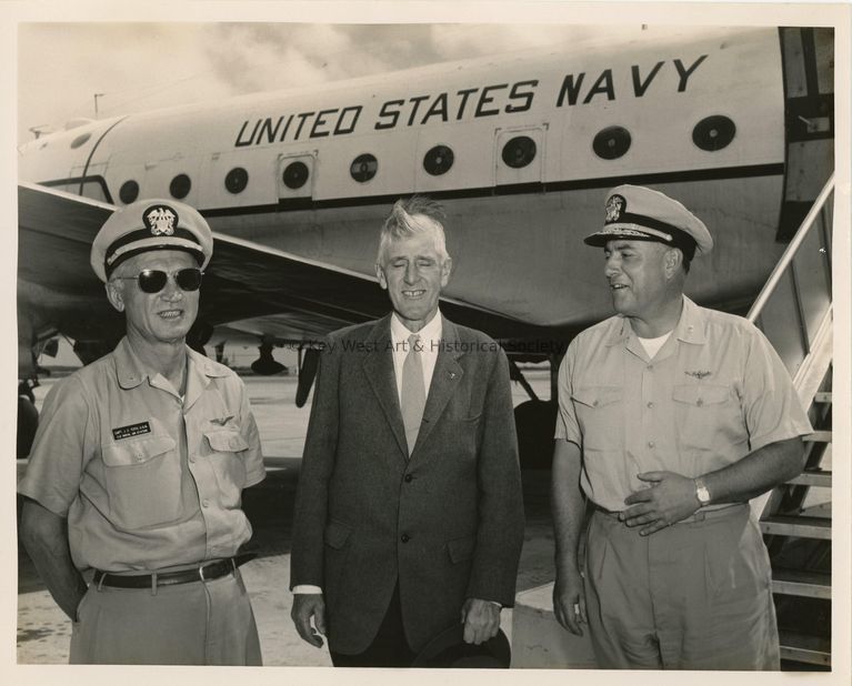 3 Men standing in front of a plane