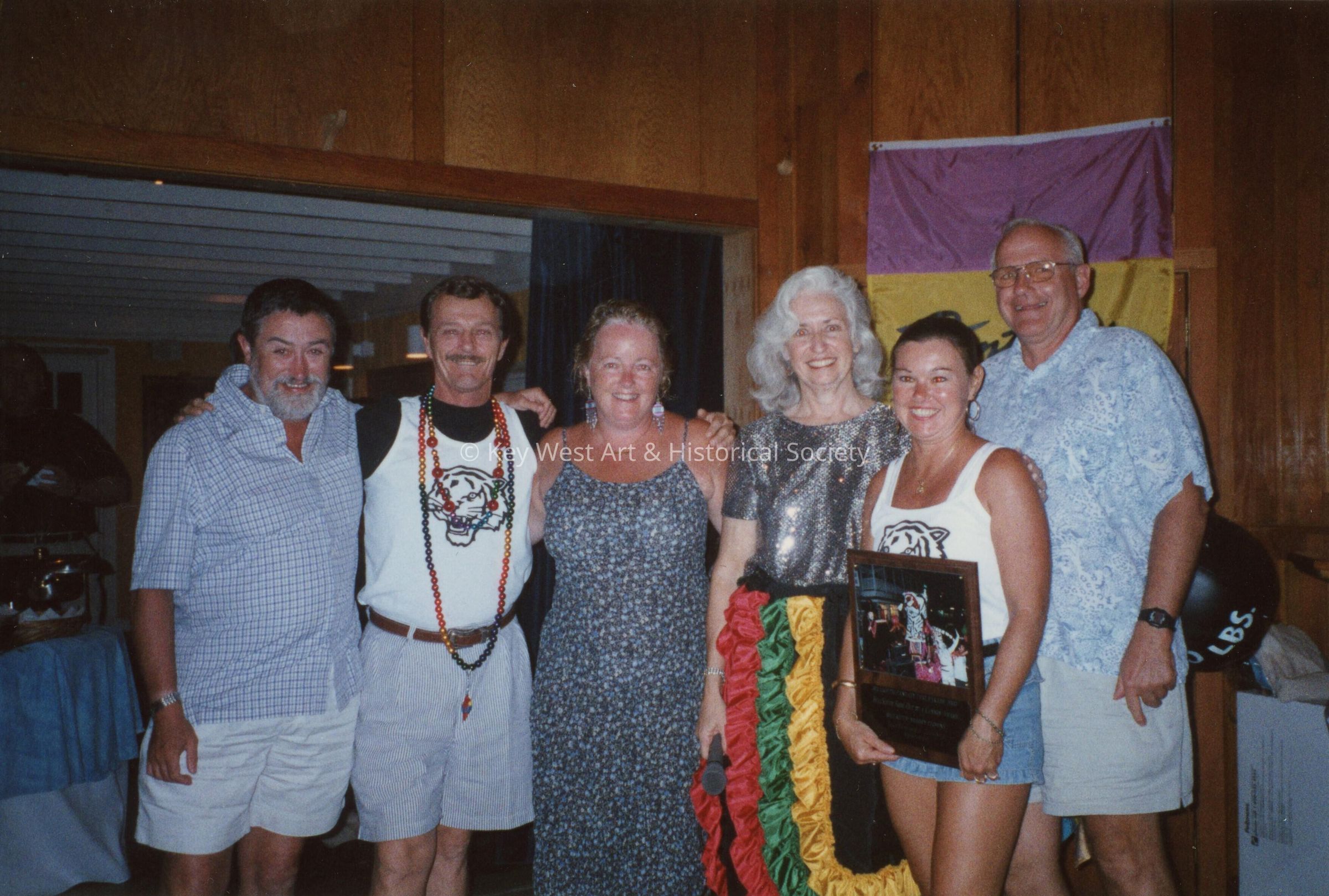 A group of unknown people at an awards ceremony.