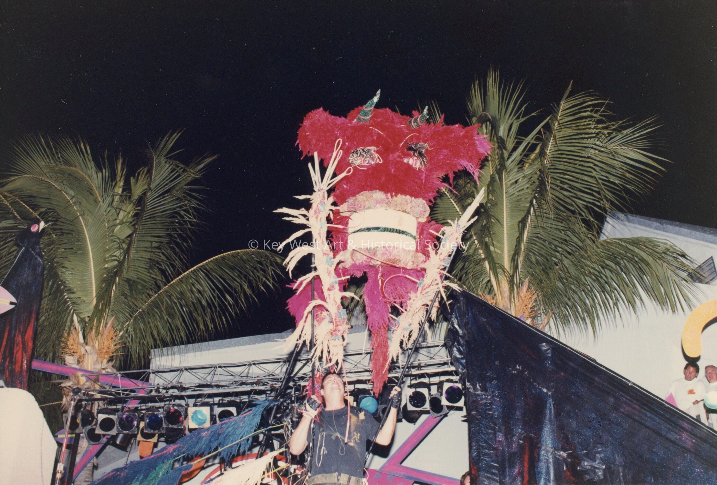 An unknown man holding some sort of costume.