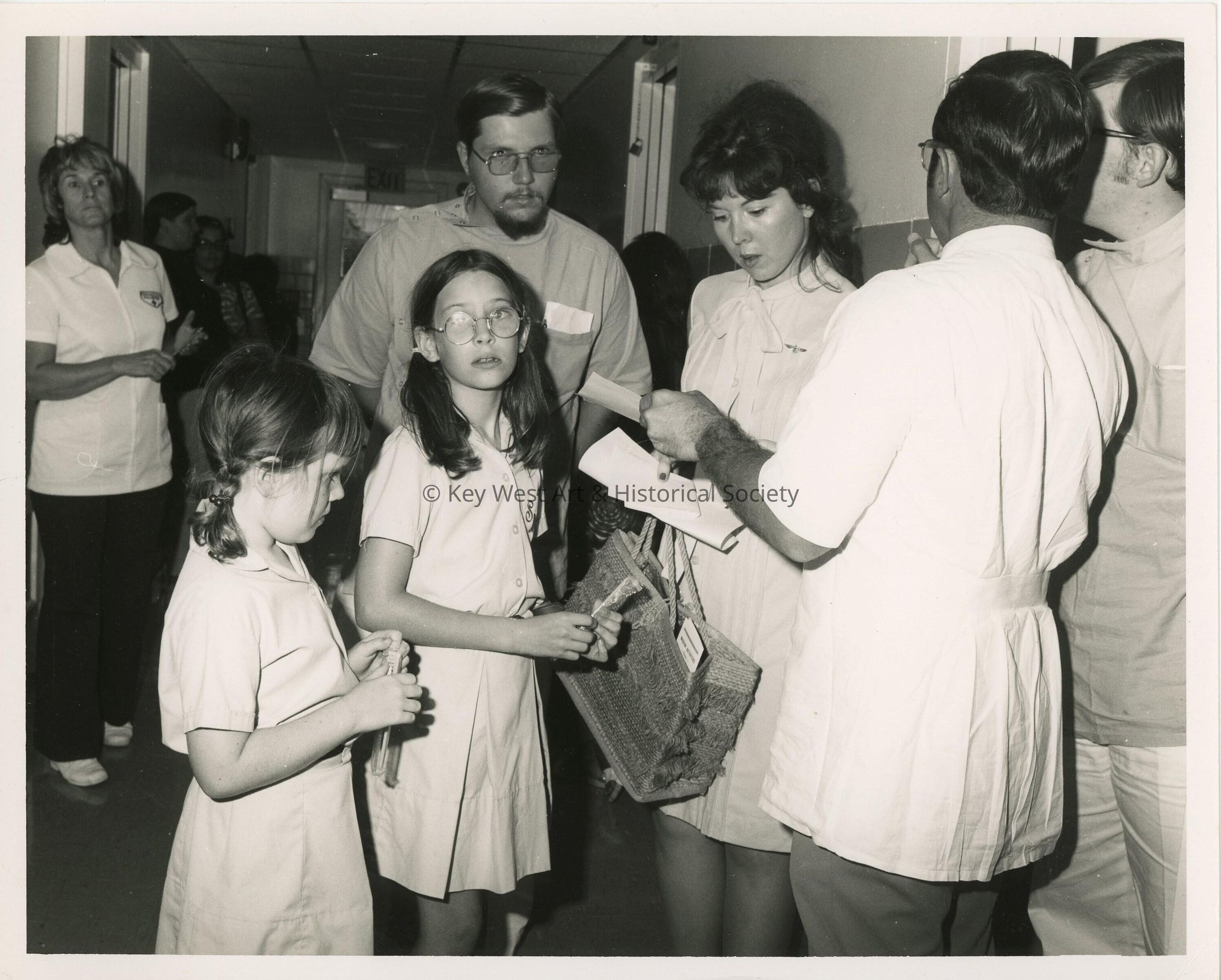 A group of unknown people standing around