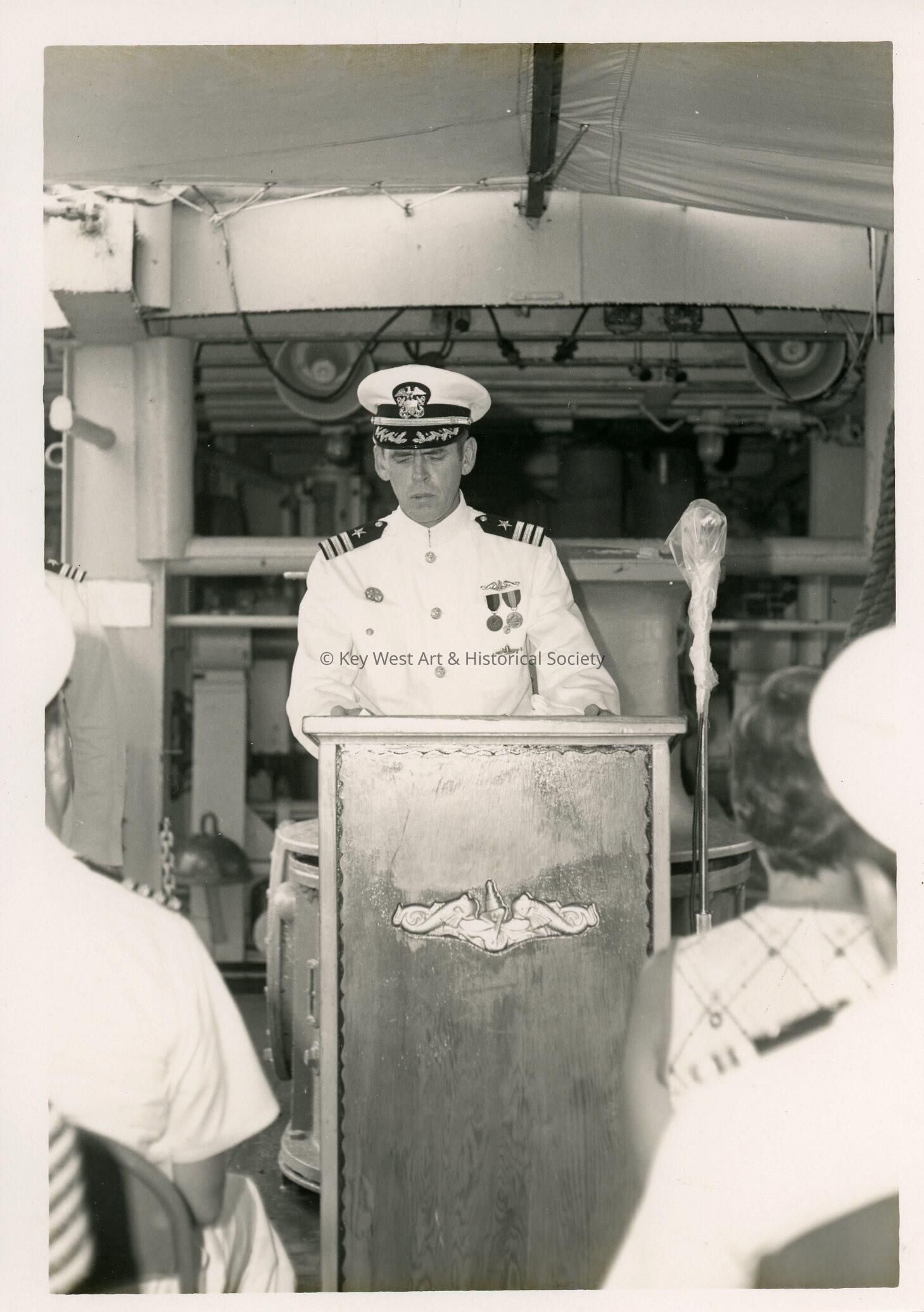 An unknown man in uniform at the podium