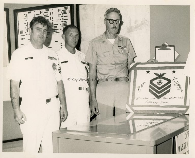 3 Unknown men in uniform at a farewell party
