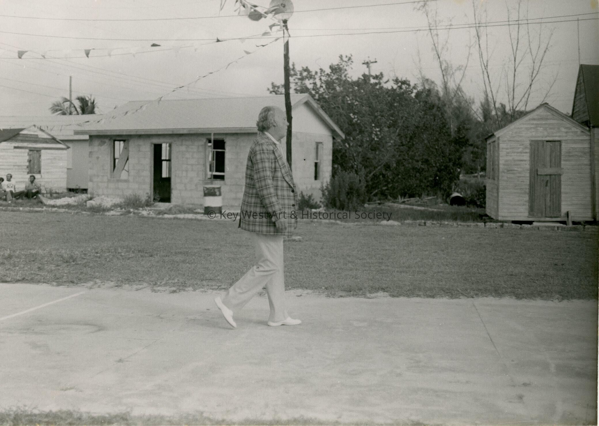 An unknown man walking down a street