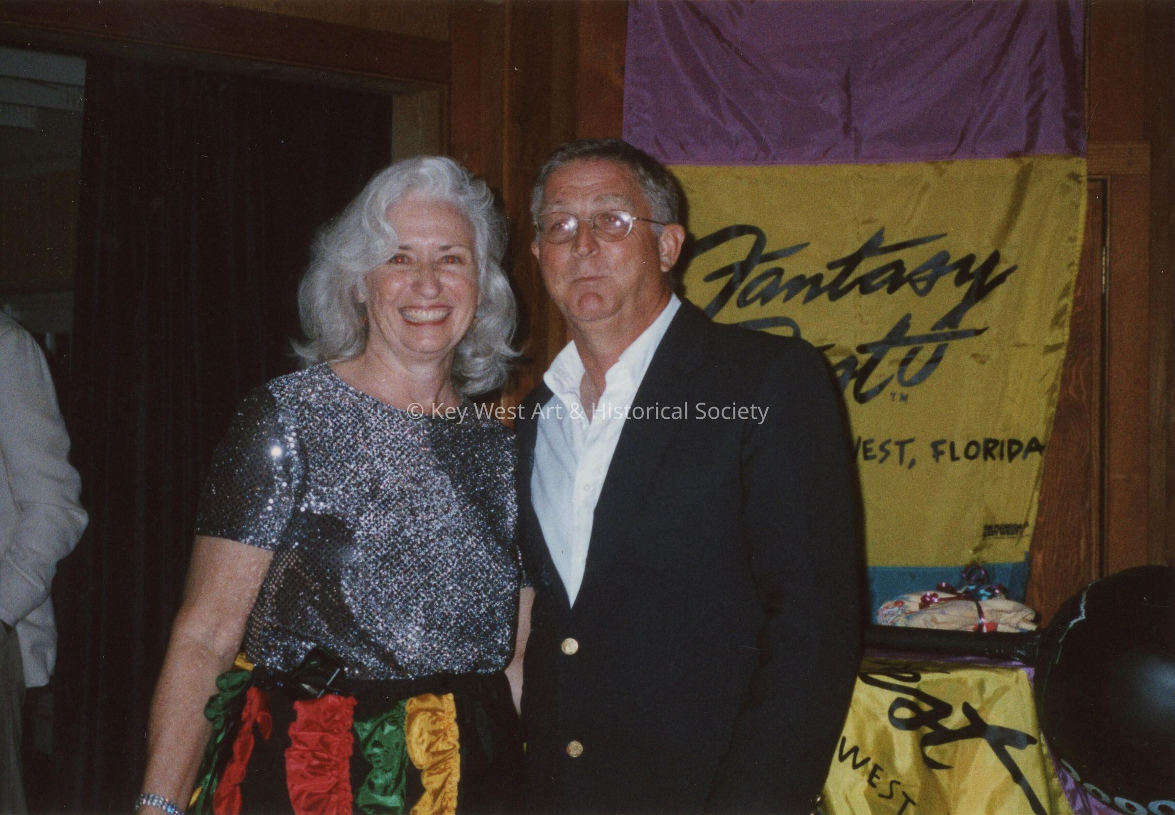 An unknown woman and man at an award ceremony.