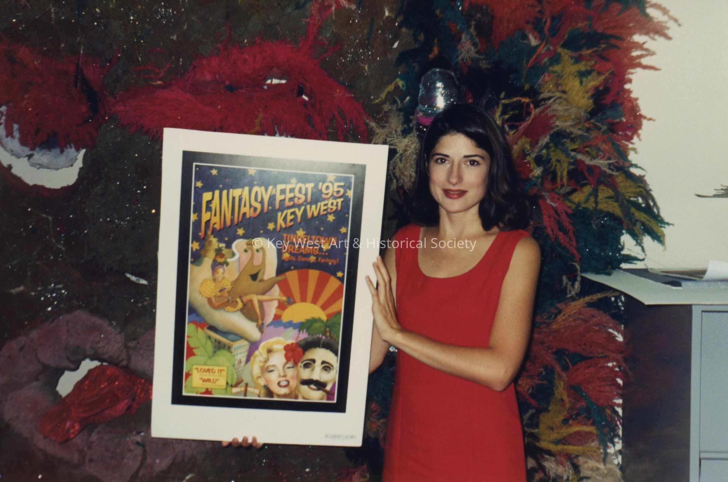An unknown woman holding a FF 1995 poster.
