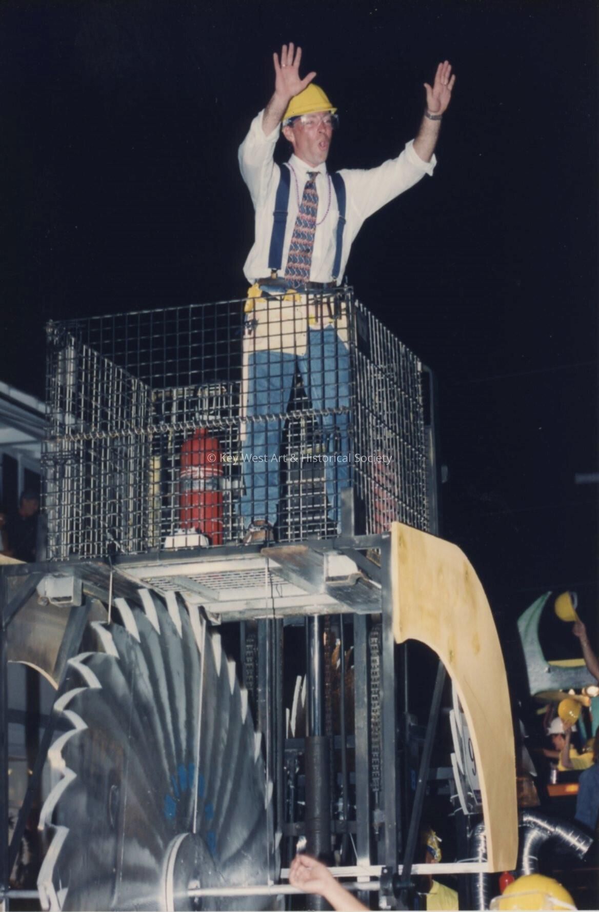 An unknown man dressed up on a float for the parade.