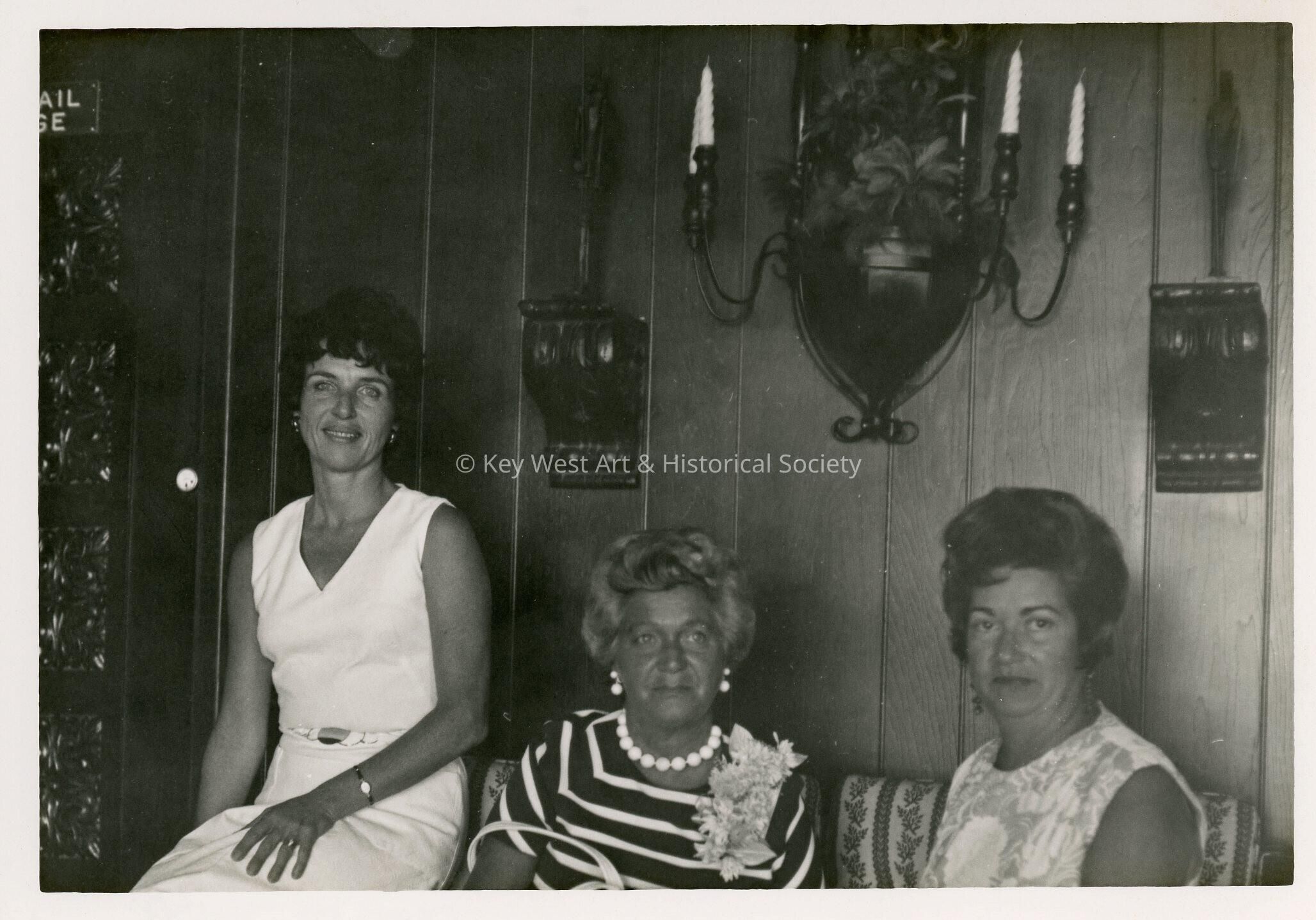 3 Unknown woman sitting in a living room